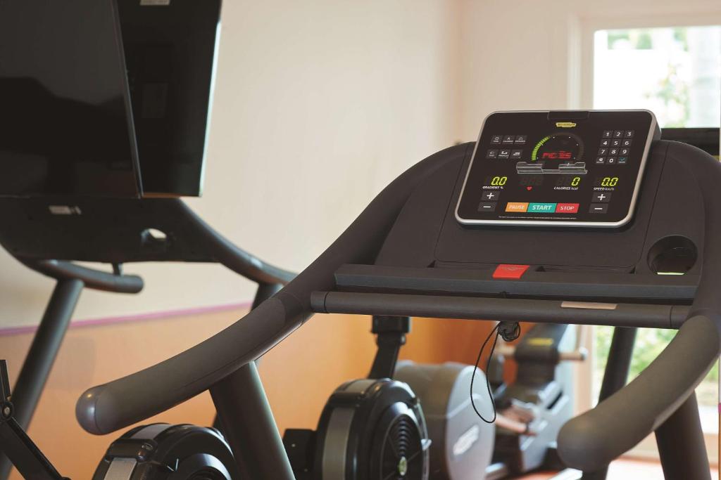 a treadmill with a cell phone on top of it at Adina Apartment Hotel Chippendale in Sydney