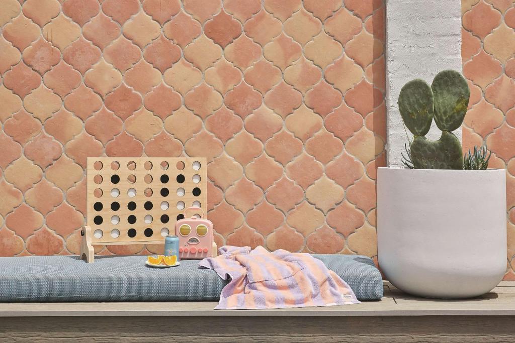 a shelf with a potted plant next to a wall at Adina Apartment Hotel Chippendale in Sydney