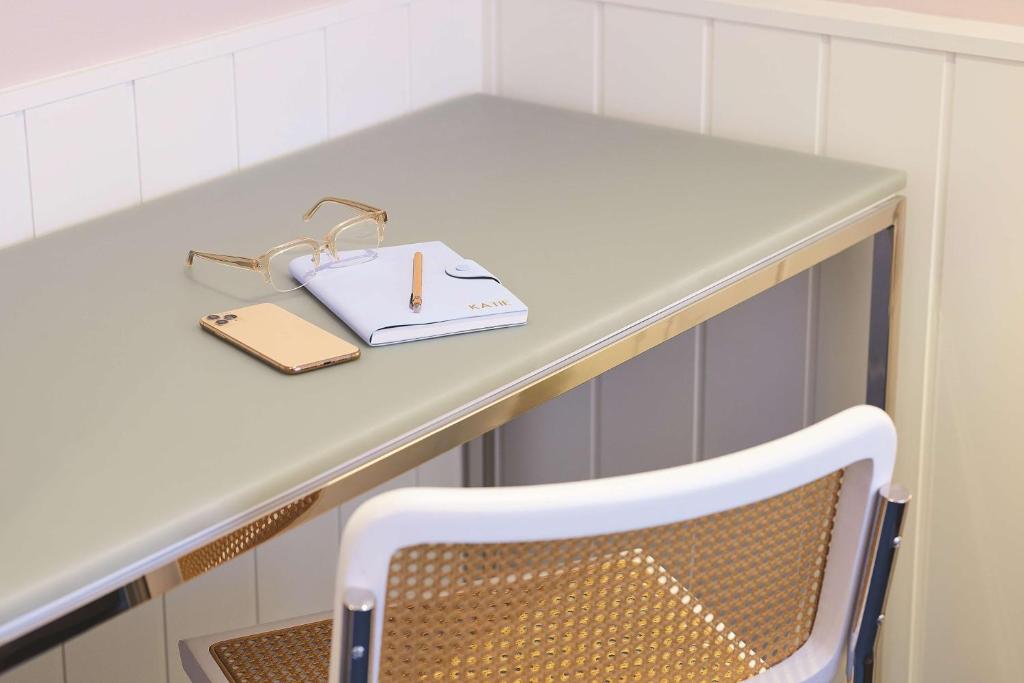 a table and a chair with a notebook and a pencil at Adina Apartment Hotel Chippendale in Sydney