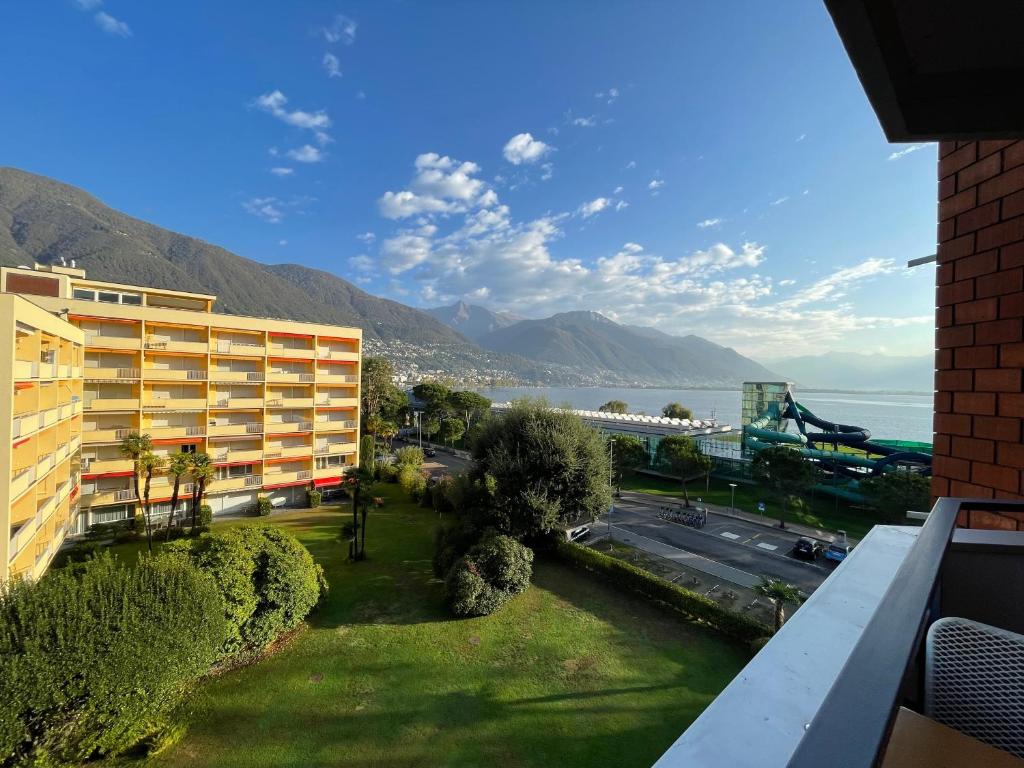 a apartment building with a view of the water at Locarno: Casa Lido in Locarno