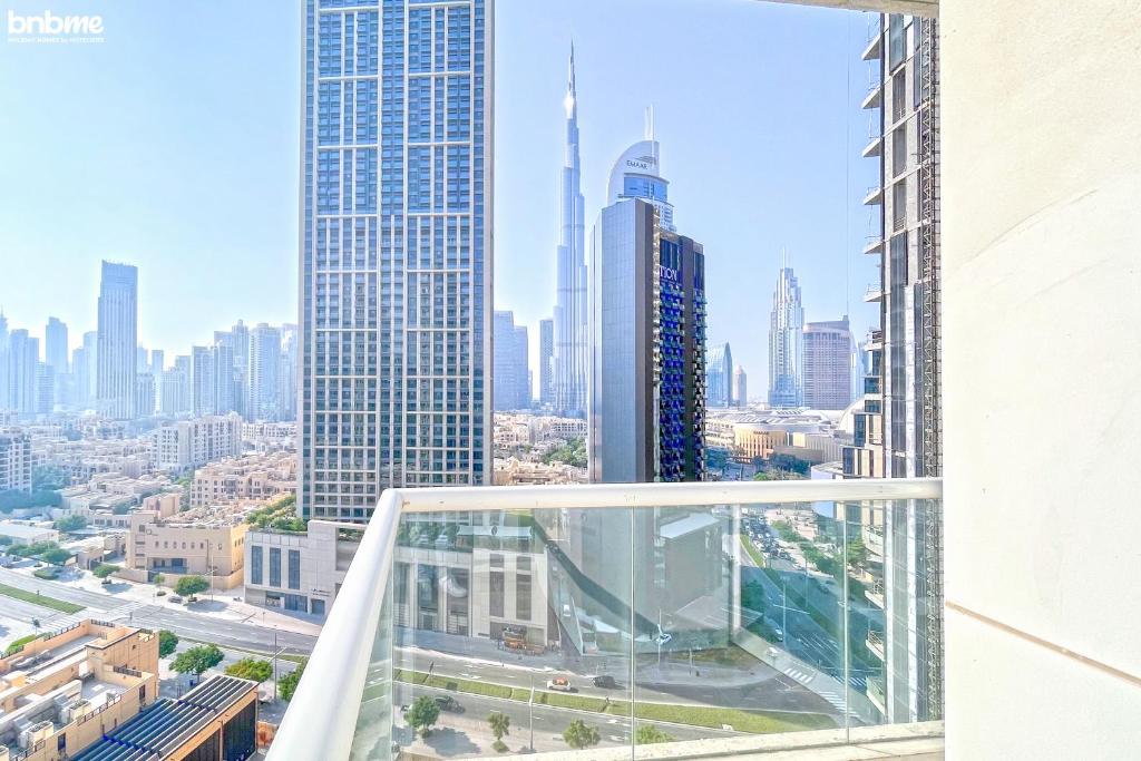 a view of the city from the balcony of a skyscraper at bnbmehomes - 2BR Apt with Burj Khalifa View -1406 in Dubai