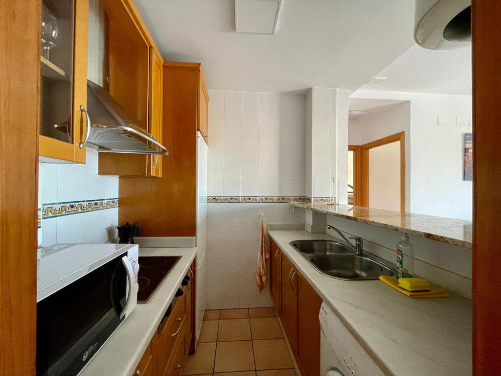 a kitchen with a sink and a dishwasher at Apartamento Gaviotas Sureñas in Tarifa