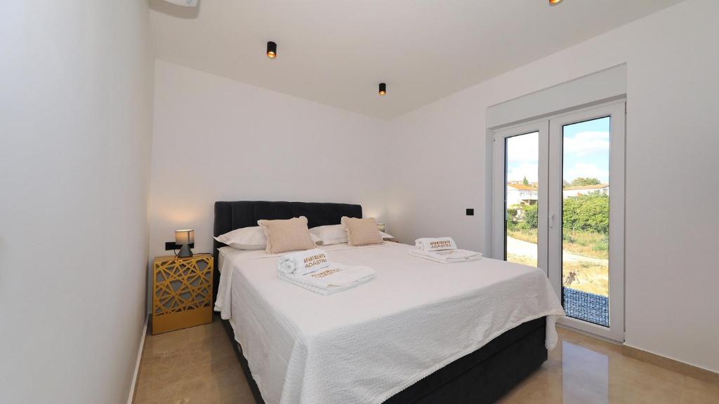 Postel nebo postele na pokoji v ubytování AdAstra Apartments
