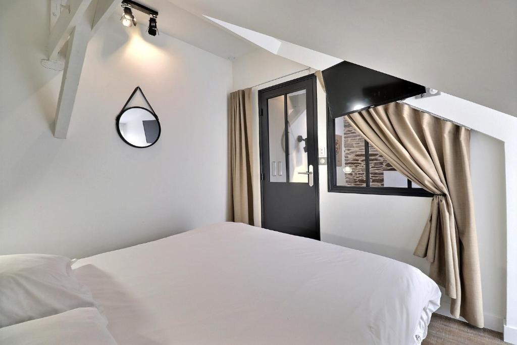 a bedroom with a white bed and a window at Garden Apparts Rennes Centre Gare in Rennes