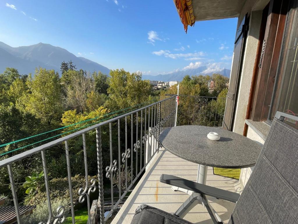 a patio with a table and chairs on a balcony at CASA PONTE: Gordola in Gordola
