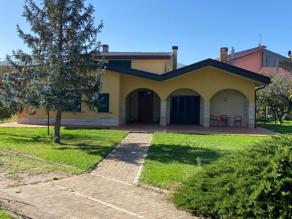 a house with a tree in front of it at Villetta degli Ulivi in Santa Rufina