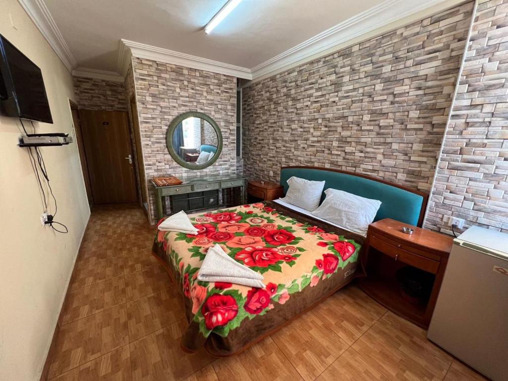 - une chambre avec un lit orné de fleurs rouges dans l'établissement Dweik Hotel 1, à Aqaba