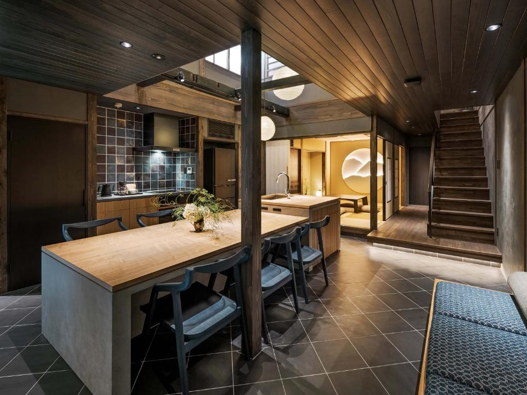 a kitchen with a wooden ceiling and a long island at Kanata Machiya House in Kanazawa