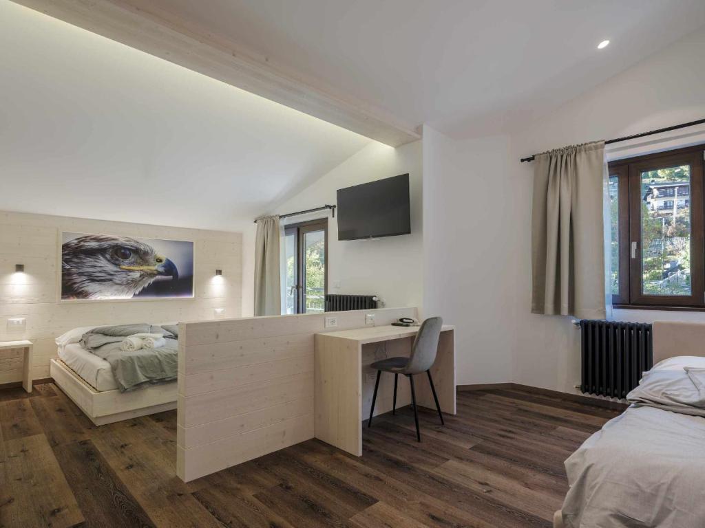 Postel nebo postele na pokoji v ubytování Hotel Garnì Alta Valle