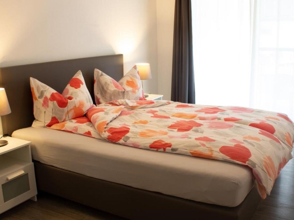 a bed with a colorful comforter in a bedroom at Ferienwohnung Gute Zeit - Apartment 2 in Bleialf