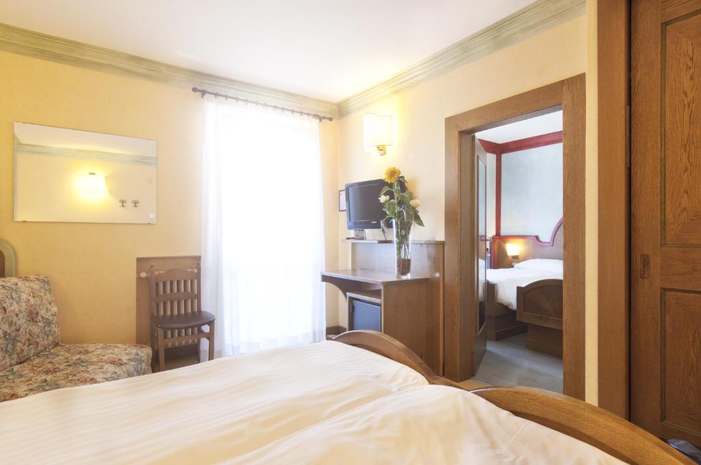 Postel nebo postele na pokoji v ubytování Grand Hotel Biancaneve