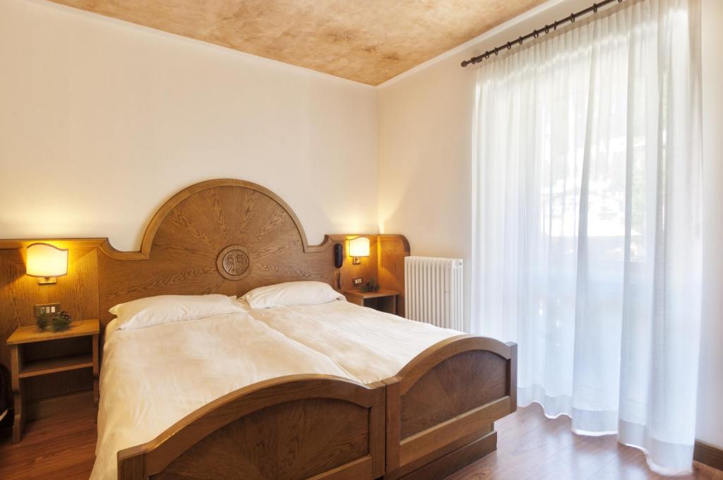 Postel nebo postele na pokoji v ubytování Grand Hotel Biancaneve
