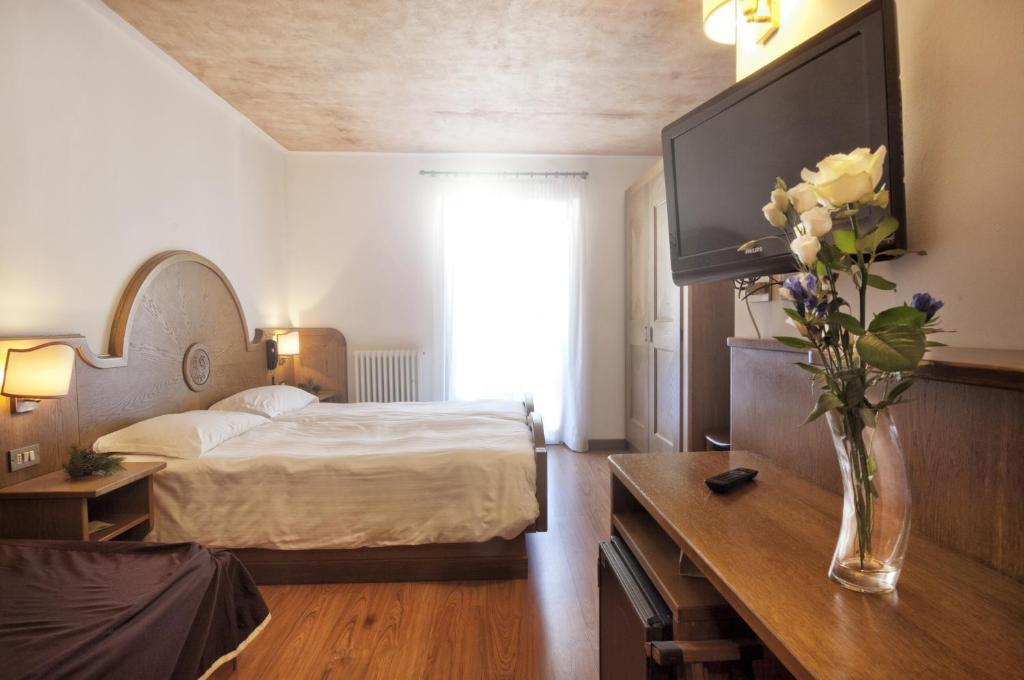 Postel nebo postele na pokoji v ubytování Grand Hotel Biancaneve