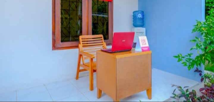 a desk with a laptop and a chair on it at Tiffany Garden in Mangsit