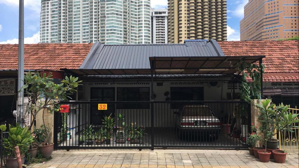 a house with a metal roof and a black gate at Tiong Nam 32 Kuala Lumpur, 6 mins to LRT PWTC, 15 mins to KLCC in Kuala Lumpur