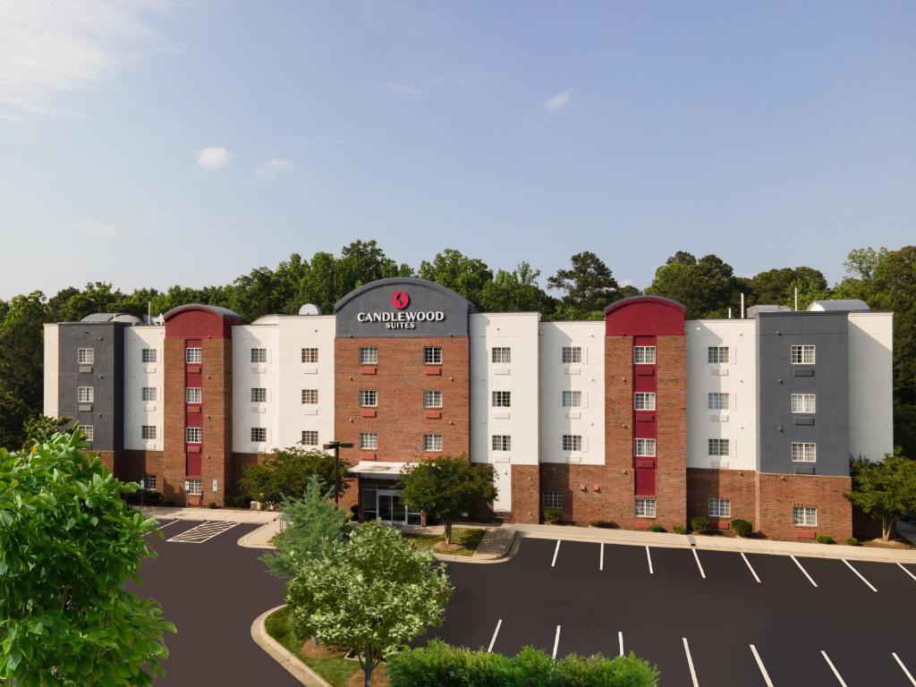 an image of an apartment building with a parking lot at Candlewood Suites Apex Raleigh Area, an IHG Hotel in Apex