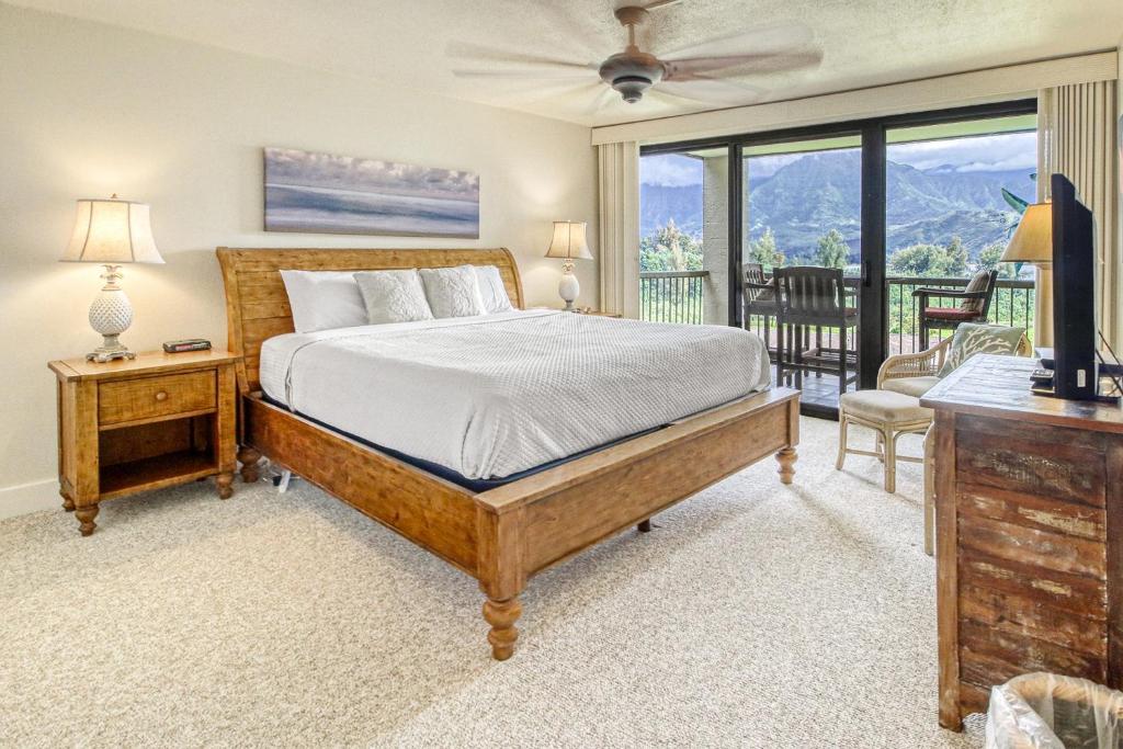a bedroom with a bed and a balcony at Hanalei Bay Resort 4204 in Princeville