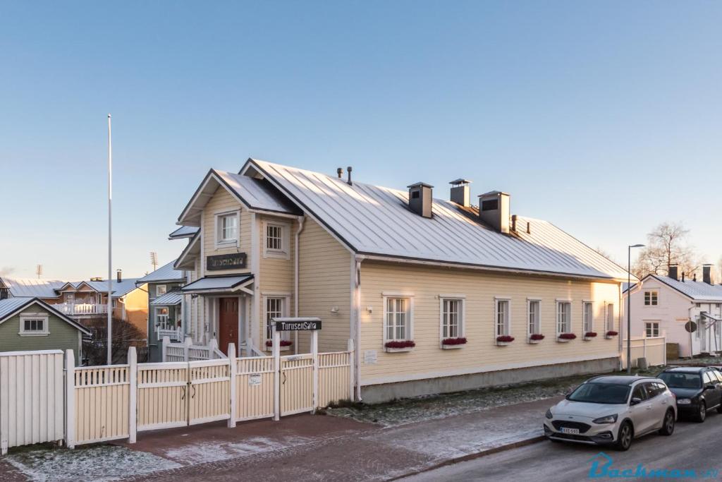 a house with a car parked in front of it at TurusenSaha Guesthouse in Oulu