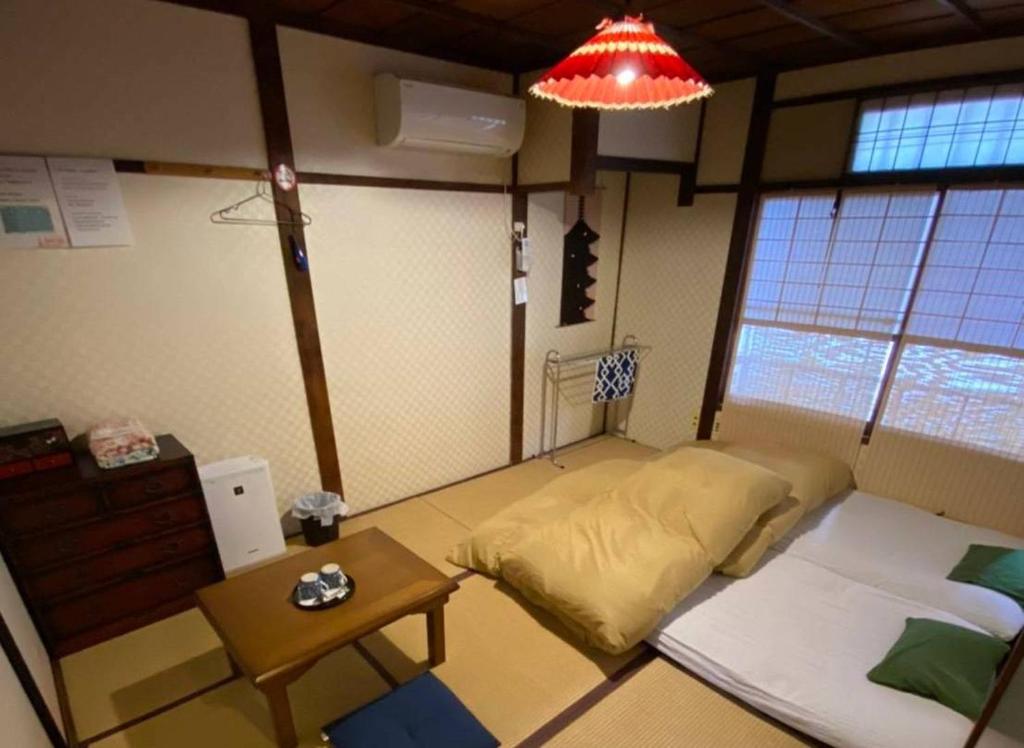 a room with a bed and a table in it at Hanakiya in Kyoto