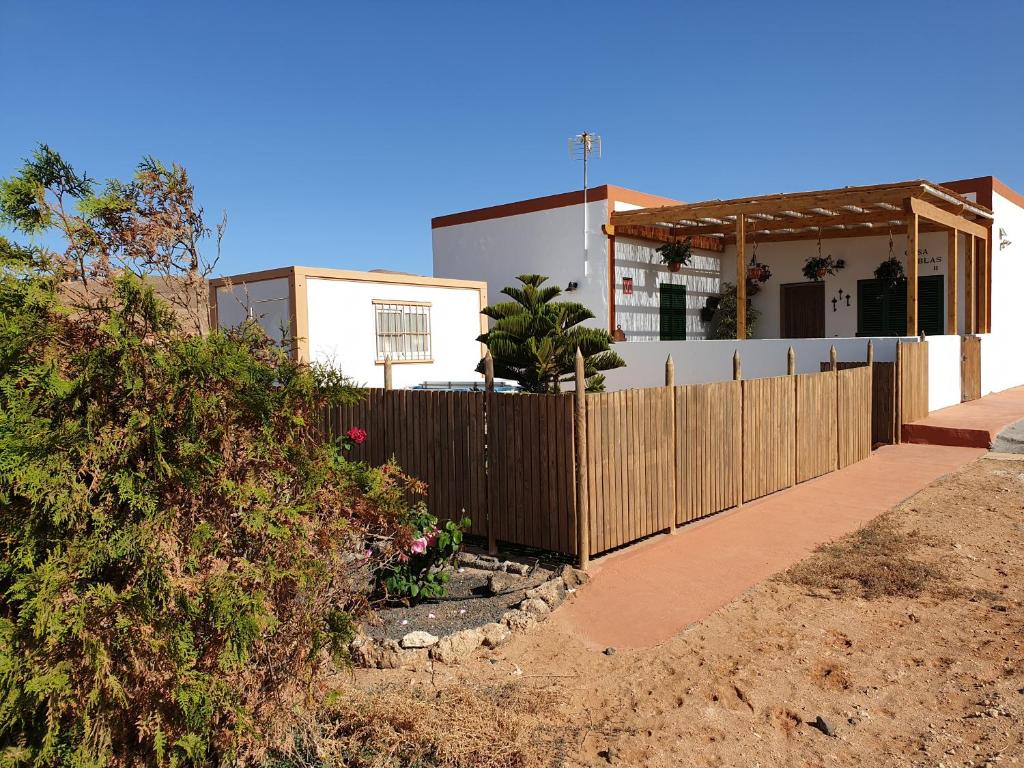 a house with a wooden fence in front of it at Casa Blas in Puerto del Rosario