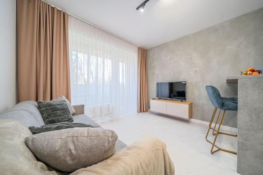 a living room with a couch and a tv at Style apartment studio Kabeny in Michalovce