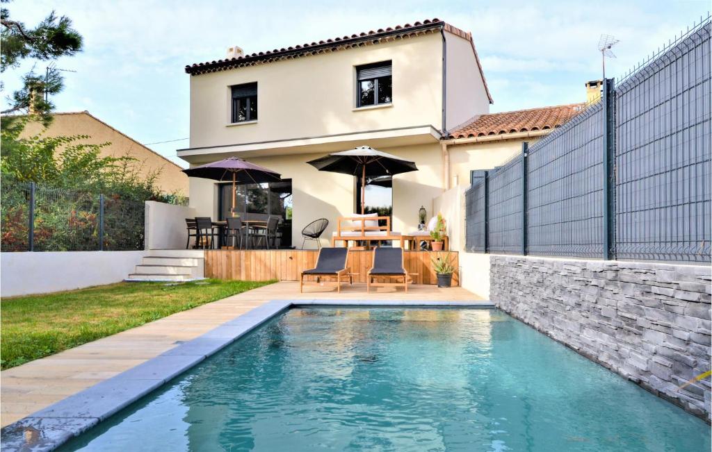 ein Haus mit einem Pool vor einem Haus in der Unterkunft Gorgeous Home In Montfavet With Outdoor Swimming Pool in Montfavet