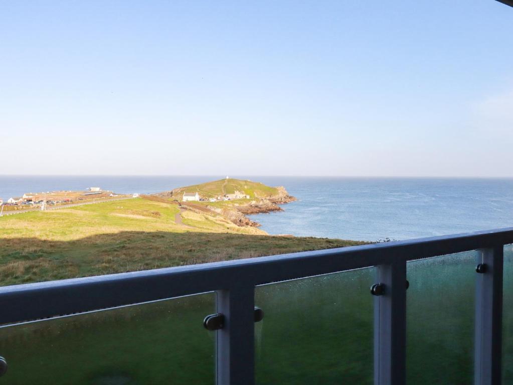 a view of the ocean from a balcony at 9 Headland Point in Newquay