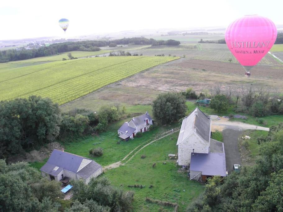 un globo aerostático sobrevolando una granja en Le Bois Davy en Le Thoureil