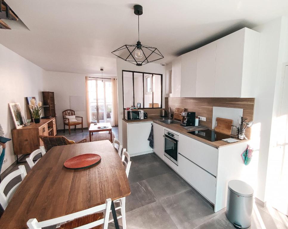 a kitchen and dining room with a wooden table at Gritxu Etxea in Biarritz