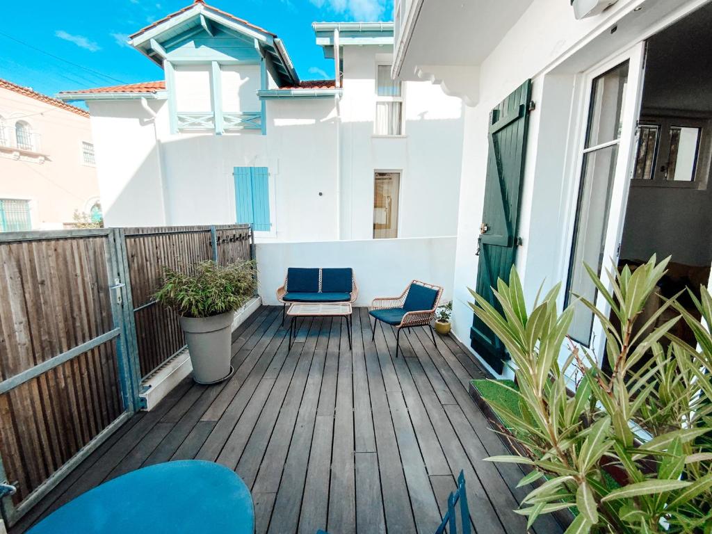 a balcony of a house with blue chairs at Gritxu Etxea in Biarritz