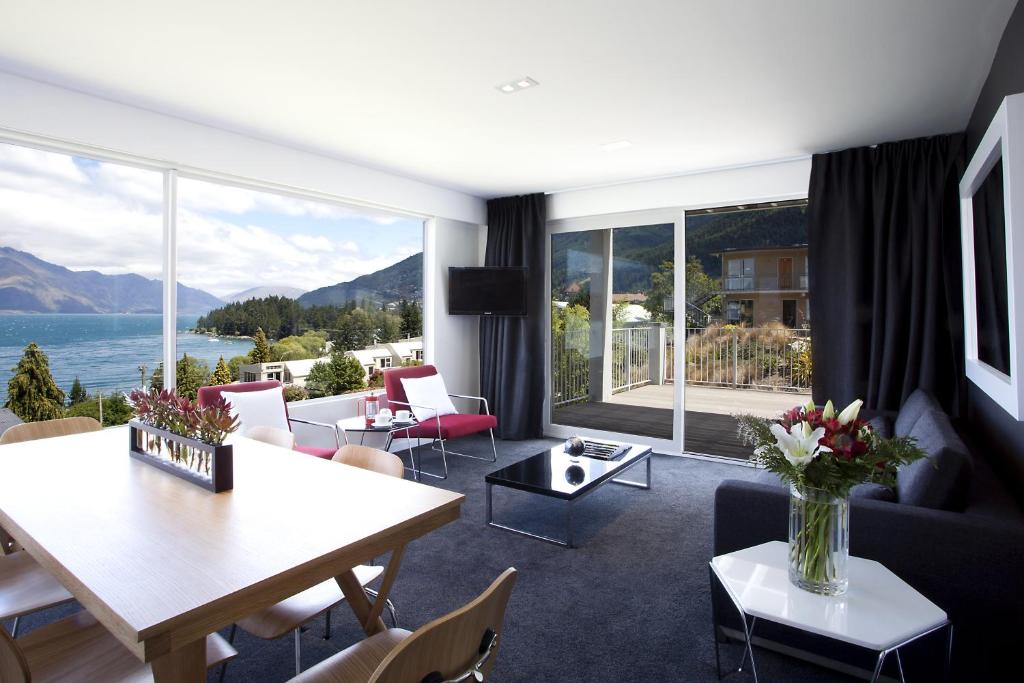 a living room with a view of the water at Casa Vista Apartment by Amazing Accom in Queenstown