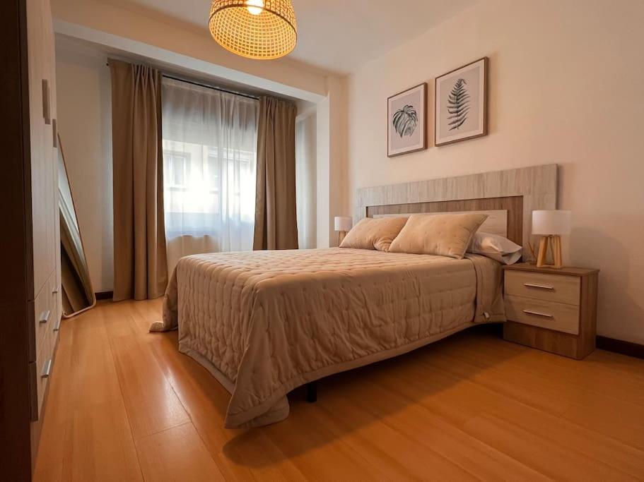 a bedroom with a large bed and a window at MoMA Meanas Aviles Centro in Avilés