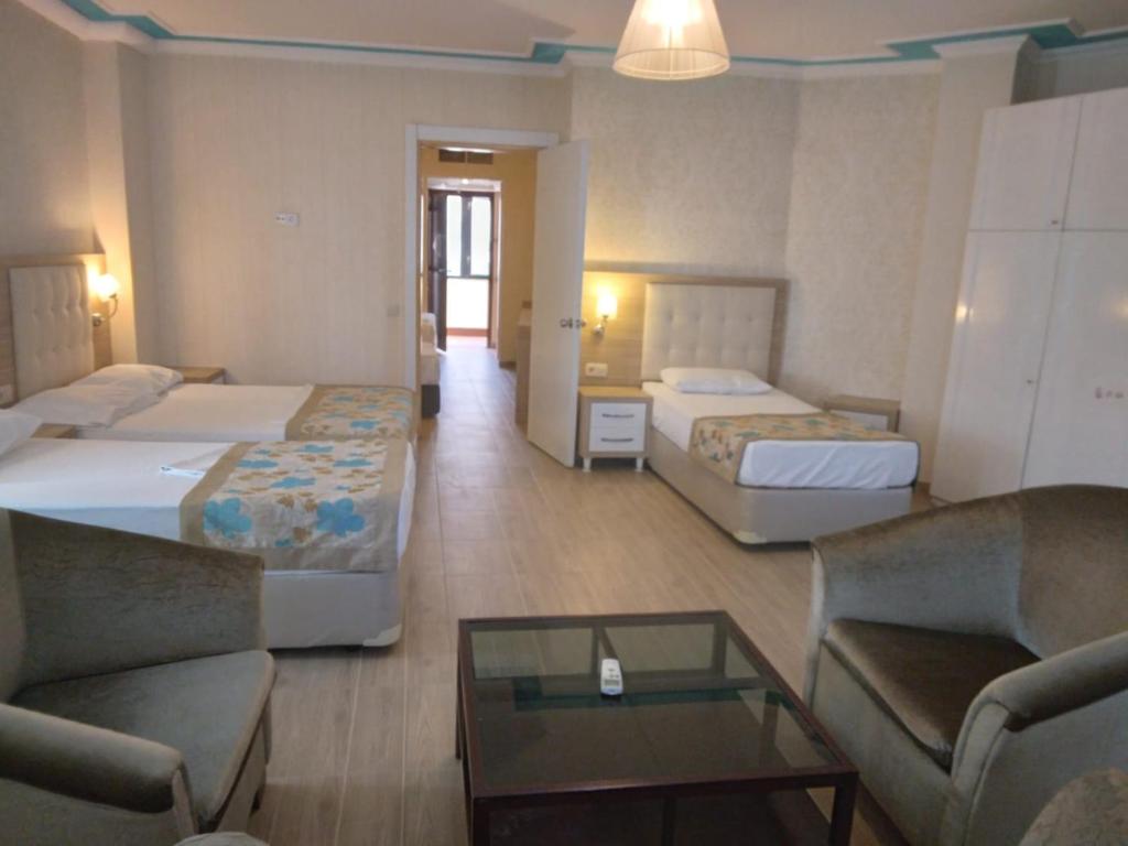 A bed or beds in a room at Cender Hotel