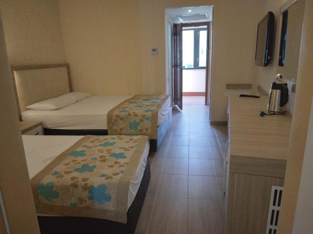 A bed or beds in a room at Cender Hotel
