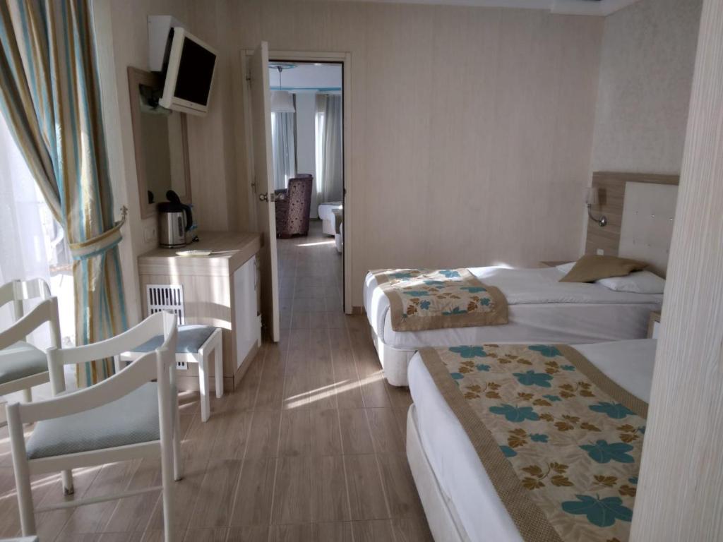 A bed or beds in a room at Cender Hotel