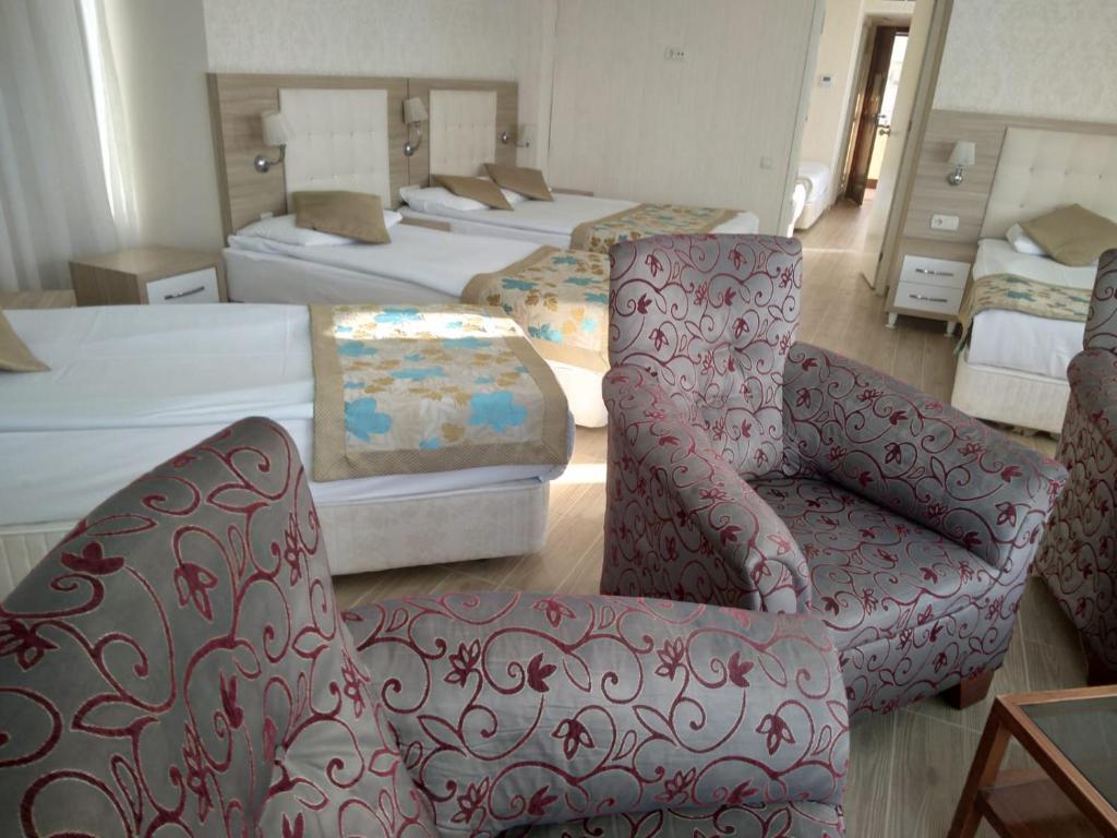 A bed or beds in a room at Cender Hotel