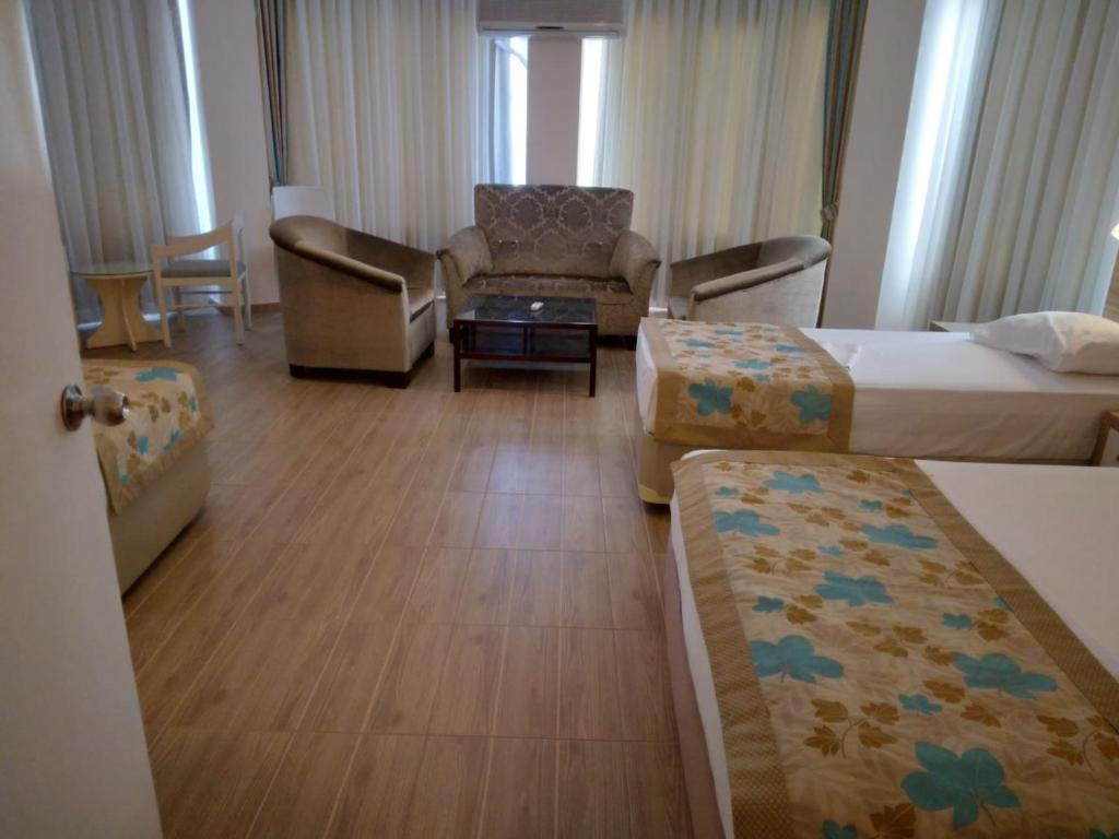 A bed or beds in a room at Cender Hotel