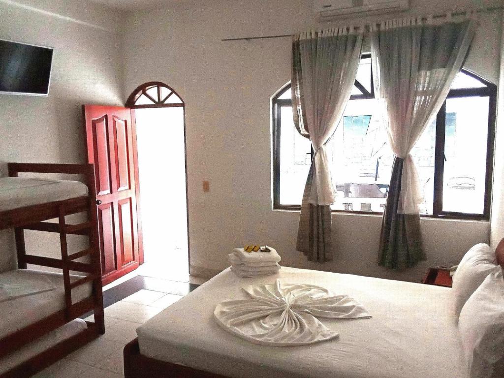 Postel nebo postele na pokoji v ubytování Suite Sumapaz Hotel