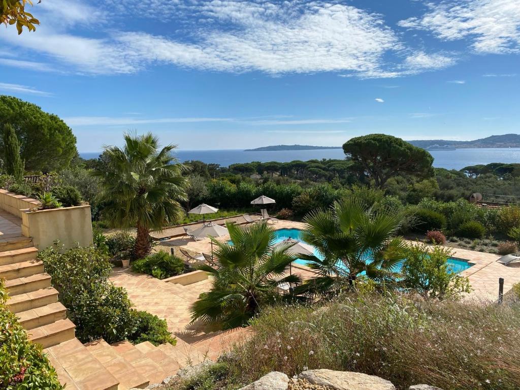 a resort with a swimming pool and a view of the ocean at La Mauresque in Grimaud