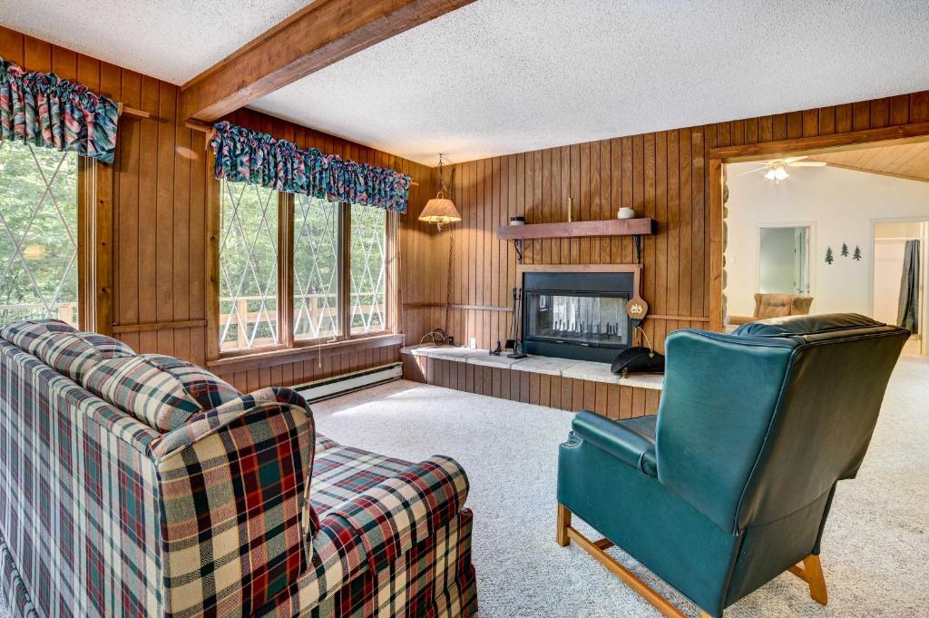 a living room with a couch and a fireplace at Charming Gaylord Getaway about 2 Mi to Golfing in Gaylord