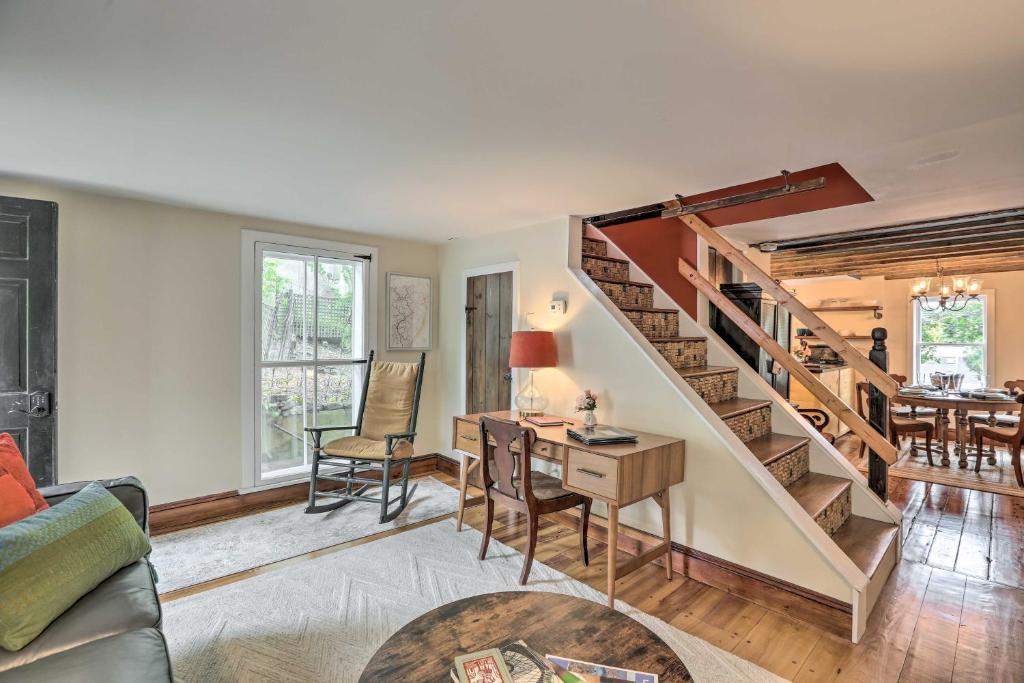 a living room with a staircase and a desk at Historic Home in Lambertville Walk to Bridge in Lambertville