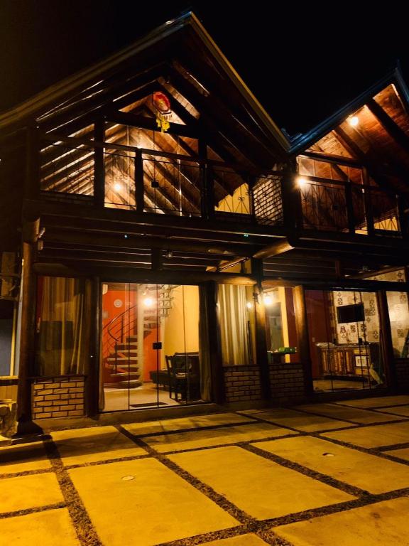 an outside view of a house at night at Encanto Chalés – 150m da Praia Grande – Penha – SC in Penha
