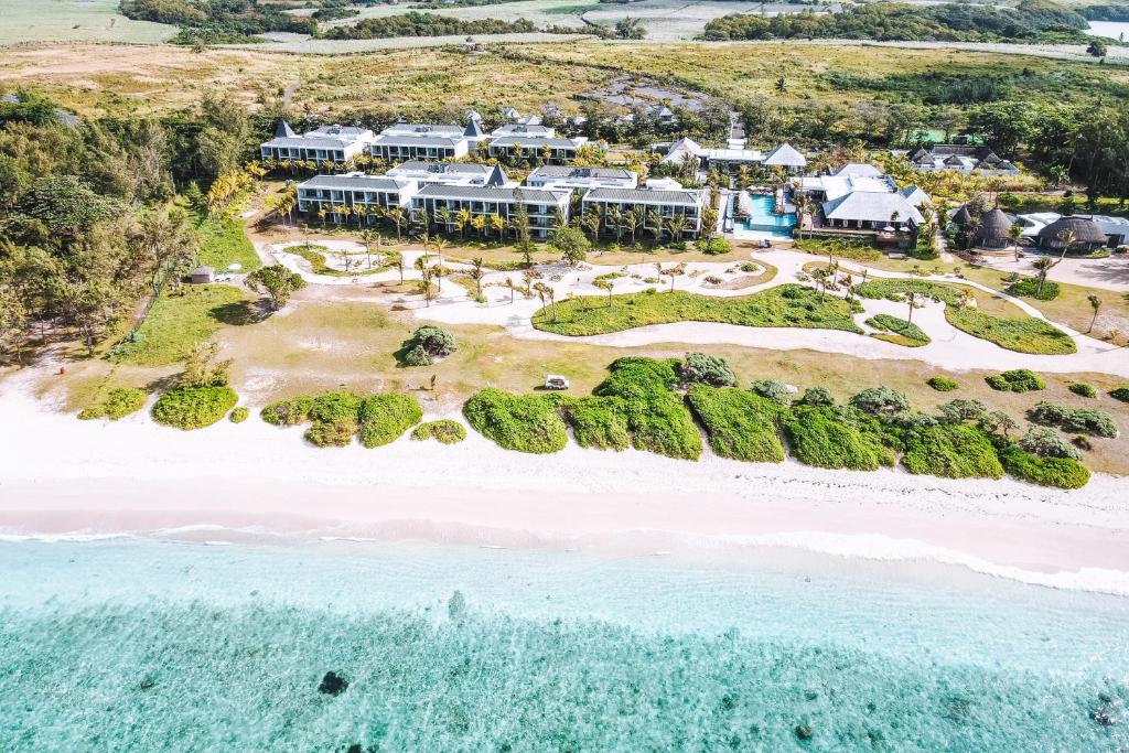 an aerial view of a resort on the beach at Anantara Iko Mauritius Resort & Villas in Blue Bay