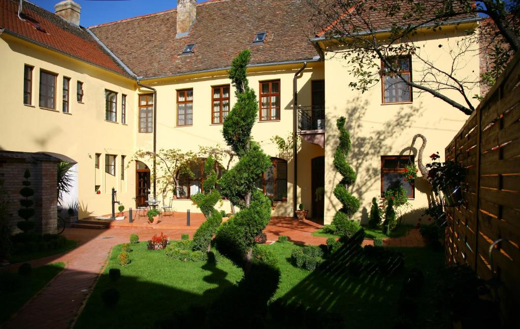 a house with a garden in front of it at Maksimilian Osijek in Osijek