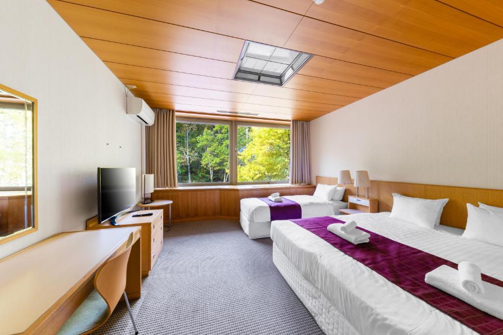 Postel nebo postele na pokoji v ubytování 151 Hakuba by Jade Group