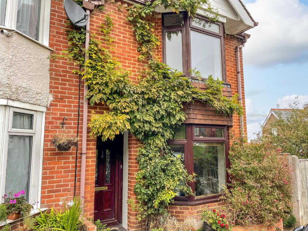 a brick house with plants on the side of it at Bay View in Swanage