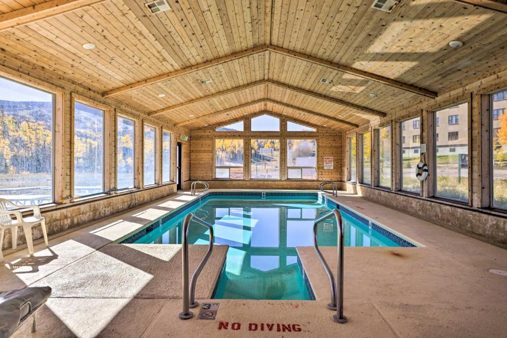 a swimming pool in a room with windows at Cozy Studio with Balcony, Walk to Brian Head Resort! in Brian Head