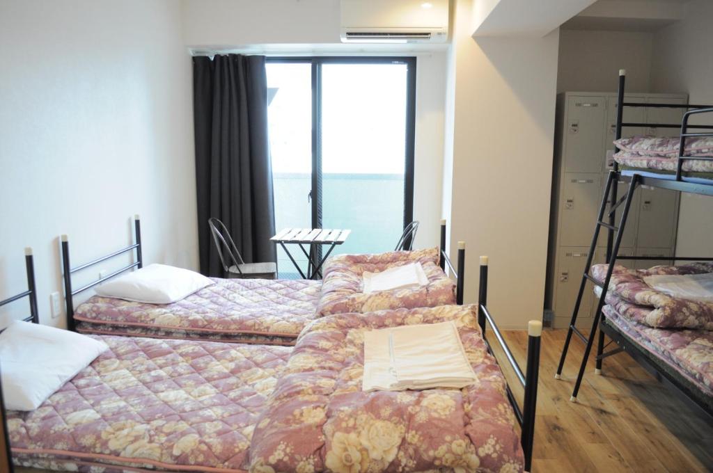 a room with four bunk beds and a large window at 04 village Namba - Vacation STAY 37120v in Osaka