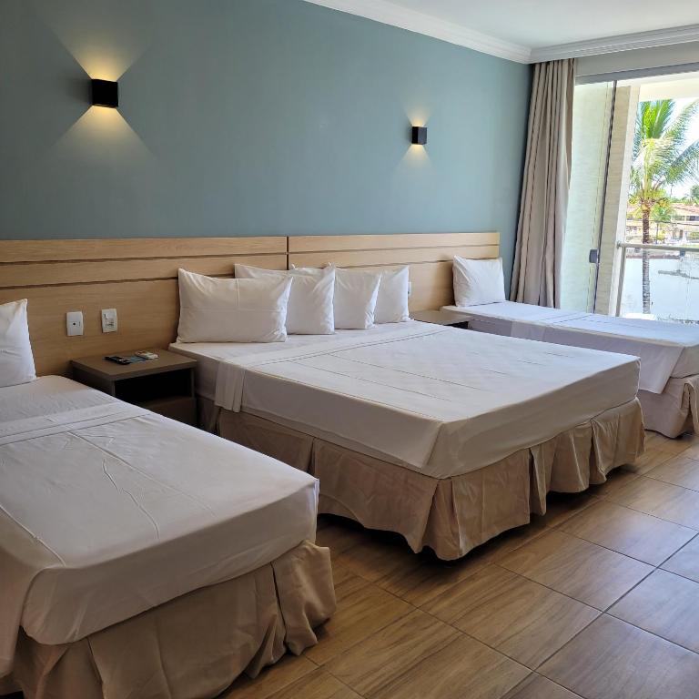 Postel nebo postele na pokoji v ubytování Porto Mar Hotel