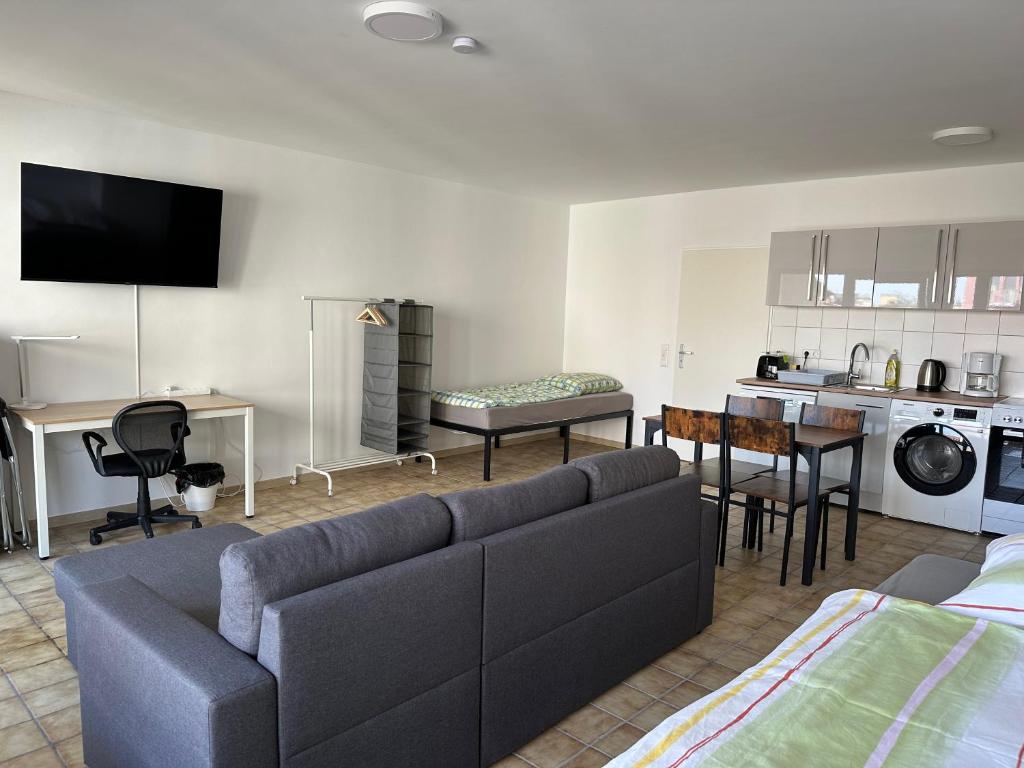 ein Wohnzimmer mit einem Sofa und einer Küche in der Unterkunft Nice, big and central apartment with 2 balconies in Karlsruhe